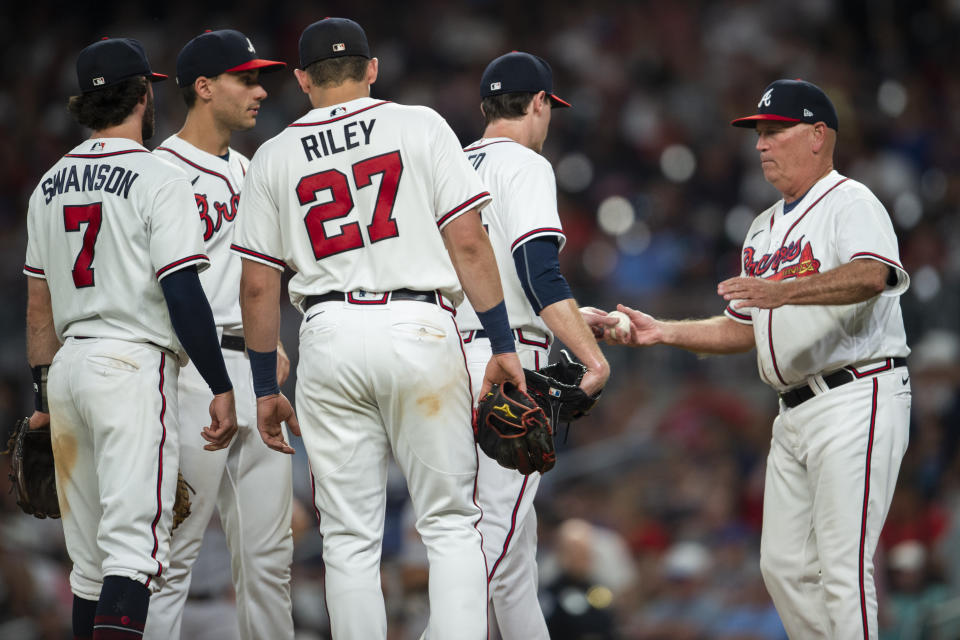 Atlanta Braves manager Brian Snitker right visits the mound to relieve starting pitcher Max Fried left for relief pitcher Will Smith in the first inning of a baseball game against the San Francisco Giants, Monday, June 20, 2022, in Atlanta. (AP Photo/Hakim Wright Sr.)