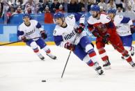 Ice Hockey – Pyeongchang 2018 Winter Olympics – Men Preliminary Round Match – Czech Republic v South Korea - Gangneung Hockey Centre, Gangneung, South Korea – February 15, 2018 - Shin Sang-hoon of South Korea controls the puck as Roman Horak of the Czech Republic follows. REUTERS/Kim Kyung-Hoon