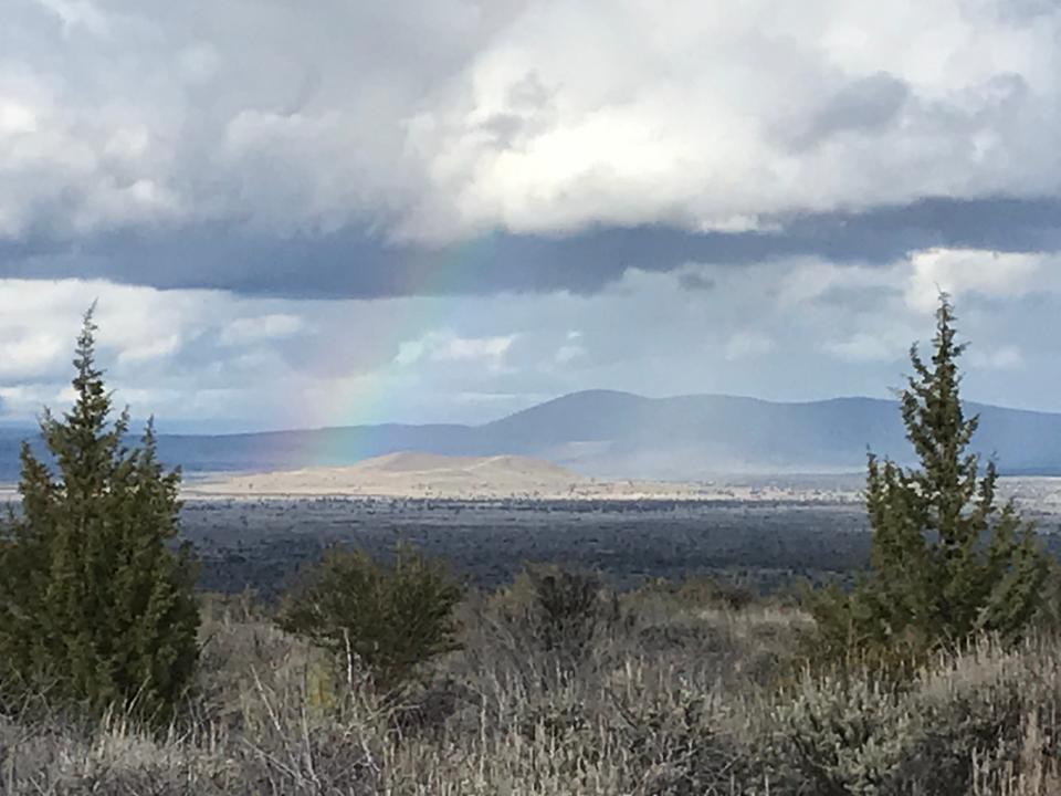 A rainbow arcs over Lava Beds National Monument in May, 2023.