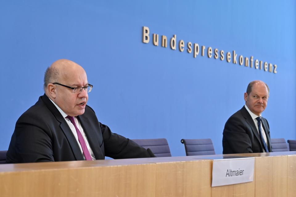 German Economy Minister Peter Altmaier, left, and German Finance Minister and Vice-Chancellor Olaf Scholz give a press conference on an aid package in response to the COVID-19 coronavirus pandemic, in Berlin, Monday April 6, 2020. Restrictions on civil liberties and social restrictions have been imposed in many countries as the highly contagious COVID-19 coronavirus sweeps the globe. (John Macdougall/Pool via AP)