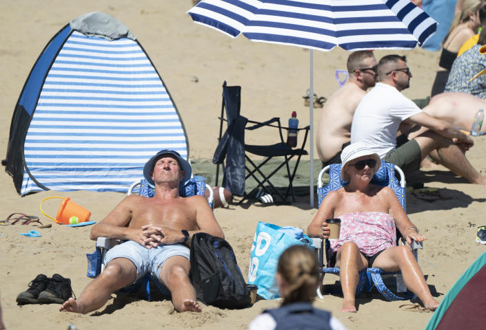 People enjoying the warm weather on Scarborough beach, North Yorkshire. Picture date: Sunday July 10, 2022.