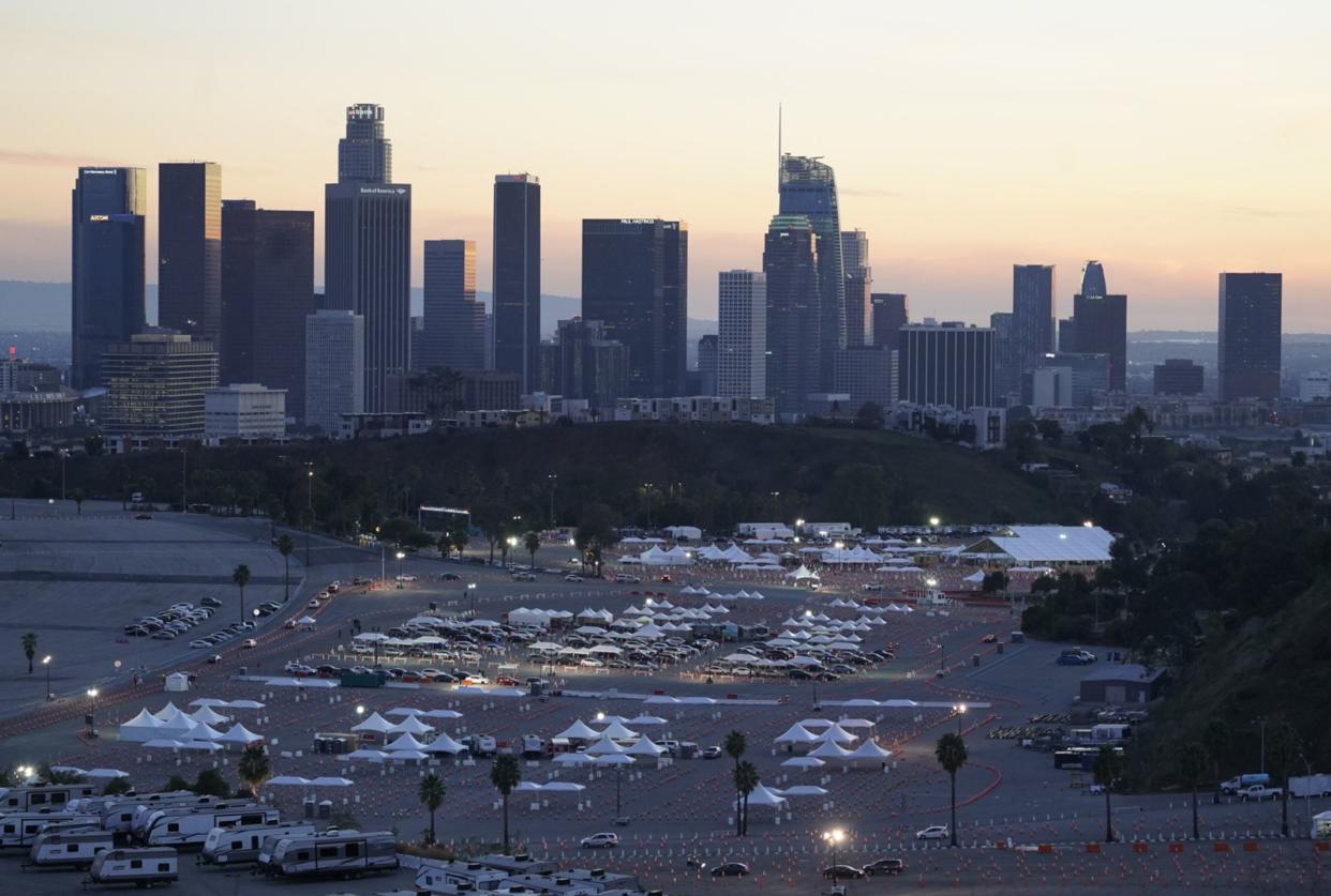 Drivers with a vaccine appointment enter a mega COVID-19 vaccination site set up in the parking lot of Dodger Stadium in Los Angeles on Saturday, Jan. 30, 2021. One of the largest vaccination sites in the country was temporarily shut down Saturday because dozen of protesters blocked the entrance, stalling hundreds of motorists who had been waiting in line for hours, the Los Angeles Times reported. The Los Angeles Fire Department shut the entrance to the vaccination center at Dodger Stadium about 2 p.m. as a precaution, officials told the newspaper. The protesters had members of anti-vaccine and far-right groups, the Times reported. Some of them carried signs decrying the COVID-19 vaccine and shouting for people not to get the shots.