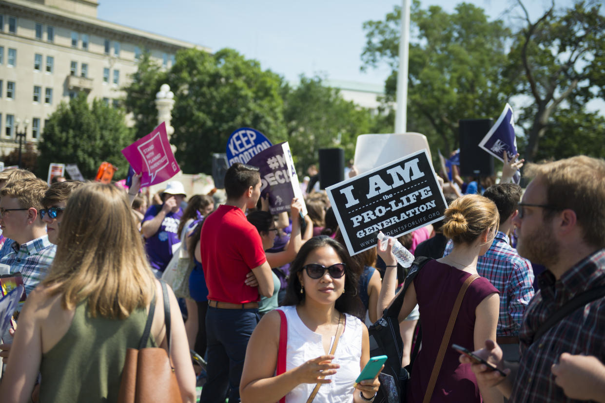 Abortion rights advocates and antiabortion supporters stand in front of the U.S. Supreme Court in 2016 after the court, in a 5-3 ruling in the case Whole Woman’s Health v. Hellerstedt, struck down a Texas abortion access law. (Photo: Getty Images)