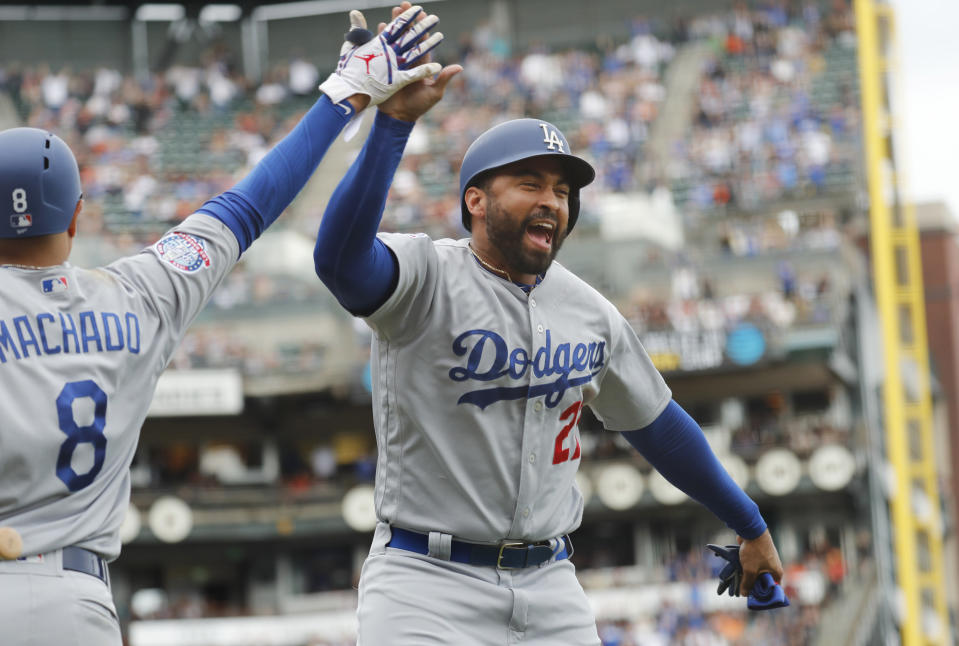 Los Angeles Dodgers' Matt Kemp (27) celebrates with Manny Machado (8) after scoring a run against the San Francisco Giants during the ninth inning of a baseball game in San Francisco, Saturday, Sept. 29, 2018. (AP Photo/Jim Gensheimer)
