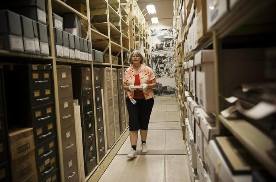 An archivist carries an item down an aisle of historical treasures at the Center for Sacramento History in 2011. The single story warehouse building, located on Sequoia Pacific Boulevard in Sacramento’s River District, is in a flood zone.