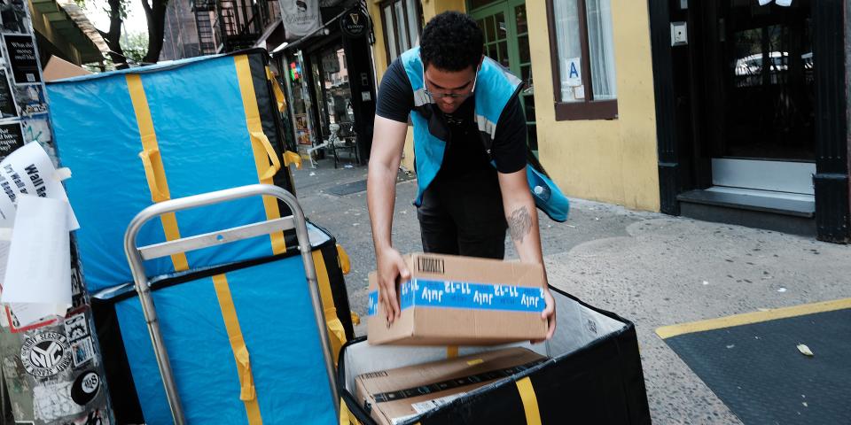 An Amazon worker moves boxes on Amazon Prime Day on July 11, 2023 in the East Village of New York City. Amazon holds the annual two-day event, where it offers shopping deals to Prime customers, in the middle of the summer. Amazon Prime Day has brought an estimated 10 billion dollars to the company in each of the last 3 years, as customers look to take advantage of discounts and quick shipping. (Photo by )