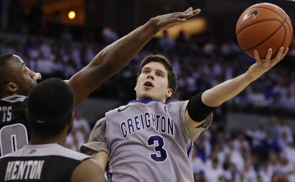 FILE - In this March 8, 2014 file photo, Creighton's Doug McDermott (3) goes for a layup against Providence's LaDontae Henton (23) and Providence's Kadeem Batts (10) in an NCAA college basketball game in Omaha, Neb. McDermott was selected to The Associated Press All-America team, released Monday, March 31, 2014. (AP Photo/Nati Harnik)