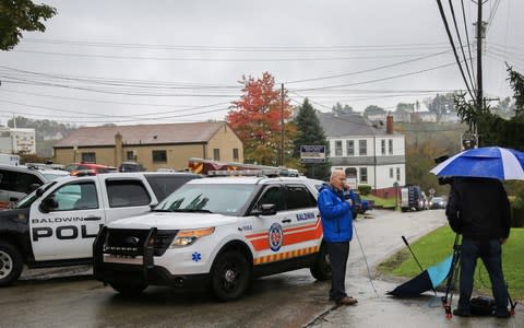 Police vehicles block off the road near the home of Pittsburgh synagogue shooting suspect Robert Bowers' home in Baldwin borough suburb of Pittsburgh - Credit: Reuters