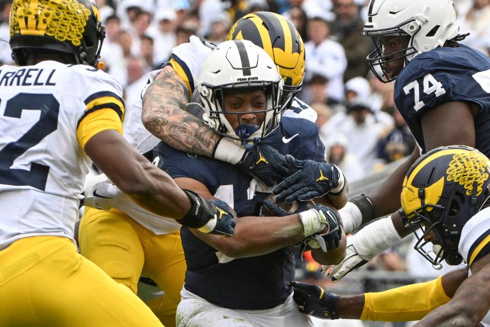 Michigan defensive end Braiden McGregor (17) tackles Penn State running back Kaytron Allen (13) last Saturday. The Nittany Lions are now 3-17 against Top 10 opponents.