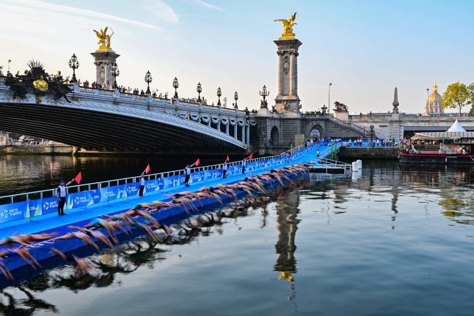Triathletes start to compete swimming in the Seine River next to the Alexandre III bridge, during a Test Event for the women's triathlon for the upcoming 2024 Olympic Games in Paris, Aug. 17, 2023. / Credit: MIGUEL MEDINA/AFP/Getty