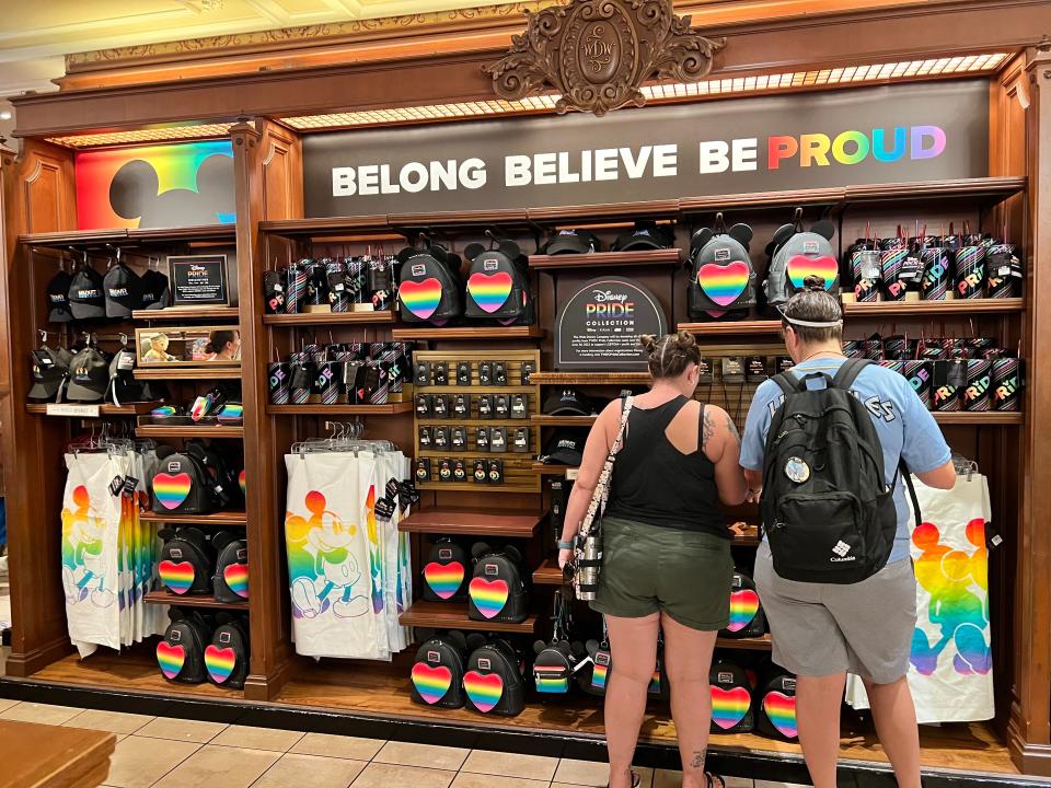 Guests peruse Pride merchandise at Magic Kingdom's Emporium.