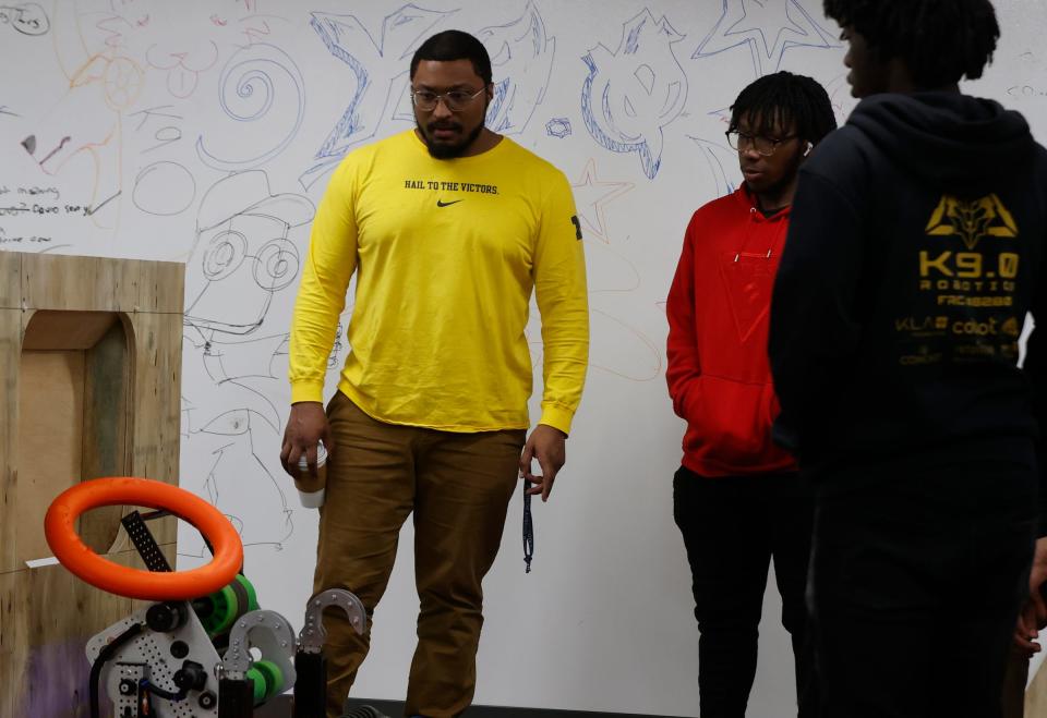 Parker Miles, a University of Michigan Ph.D. student, watches a soft ring called a note get launched by FIRST Robotics students at Marygrove High School in Detroit as they train for an upcoming robotics competition on Wednesday, March 27, 2024.