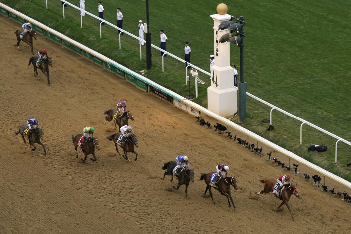 Rich Strike and jockey Sonny Leon lead the pack as they cross the finish line to win the 148th running of the Kentucky Derby horse race at Churchill Downs Saturday, May 7, 2022, in Louisville, Ky. (AP Photo/Charlie Riedel)