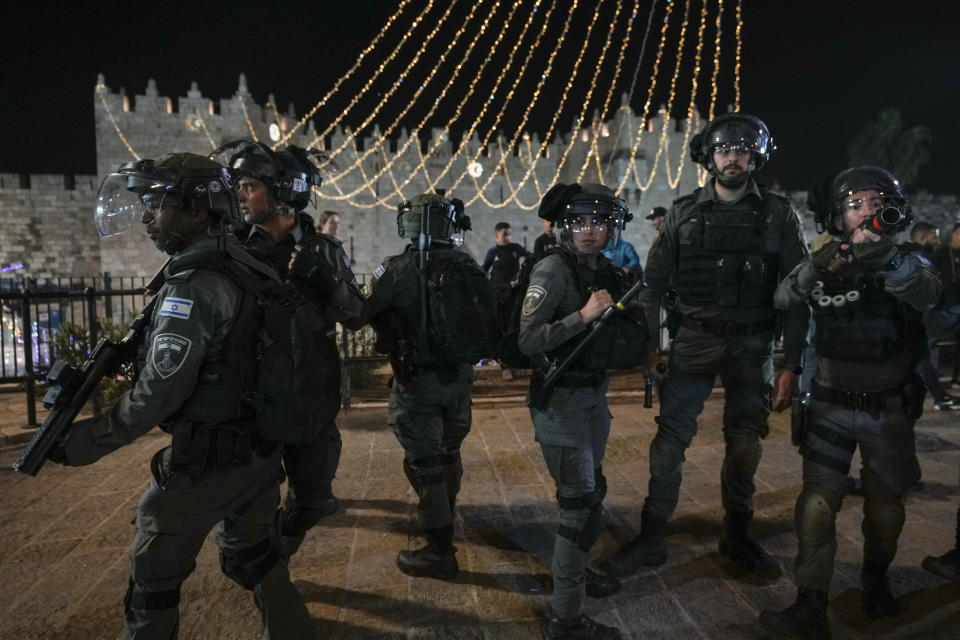 Israeli border police officers take position during clashes between Israeli security forces and Palestinians next to Damascus Gate, outside the Old City of Jerusalem, during the Muslim holy month of Ramadan, Monday, April 4, 2022. (AP Photo/Mahmoud Illean)