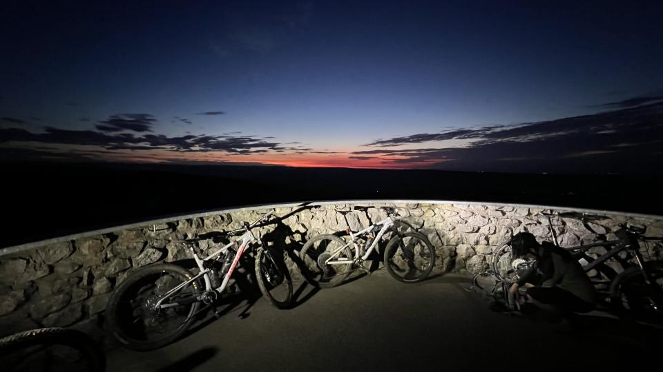 Bikes against wall at sunrise