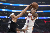 Phoenix Suns guard Bradley Beal, right, shoots as Los Angeles Clippers guard Brandon Boston Jr. defends during the first half of an NBA basketball game Wednesday, April 10, 2024, in Los Angeles. (AP Photo/Mark J. Terrill)
