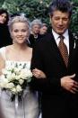 <p>In the Southern wedding of Melanie Smooter and Andrew Hennings, viewers saw Reese Witherspoon walk down the aisle in a simple cap-sleeve gown with a white bridal face net. Too bad the ceremony ended with a knockout punch, because that look was stunning.<br></p>