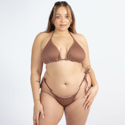 <p><a href="https://wearewewear.com/collections/all-swimwear-01/products/reversible-melissa-tie-side-bikini-top-brown-cream?variant=39368868855921" rel="nofollow noopener" target="_blank" data-ylk="slk:Shop Now;elm:context_link;itc:0;sec:content-canvas" class="link rapid-noclick-resp">Shop Now</a></p><p>Reversible Melissa Tie Side Bikini Top</p><p>$28.00</p><p>wearewewear.com</p>