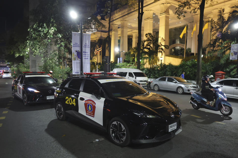 Police cars are parked outside the Grand Hyatt Erawan Hotel in Bangkok, Thailand, Tuesday, July 16, 2024. Police said a number of people were found dead Tuesday in the luxury hotel in downtown Bangkok and poisoning is suspected. (AP Photo/Chatkla Samnaingjam)