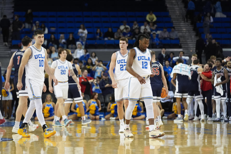 UCLA players walk off the court following the team's 88-65 loss to Arizona in an NCAA college basketball game Thursday, March 7, 2024, in Los Angeles. (AP Photo/Jae C. Hong)