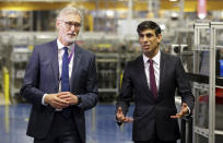 Britain's Chancellor of the Exchequer Rishi Sunak talks with the CEO of Worcester Bosch, Carl Arntzen, left, during a visit to Worcester Bosch factory to promote the initiative, Plan for Jobs, in Worcester, England, Thursday July 9, 2020. (Phil Noble/Pool via AP)