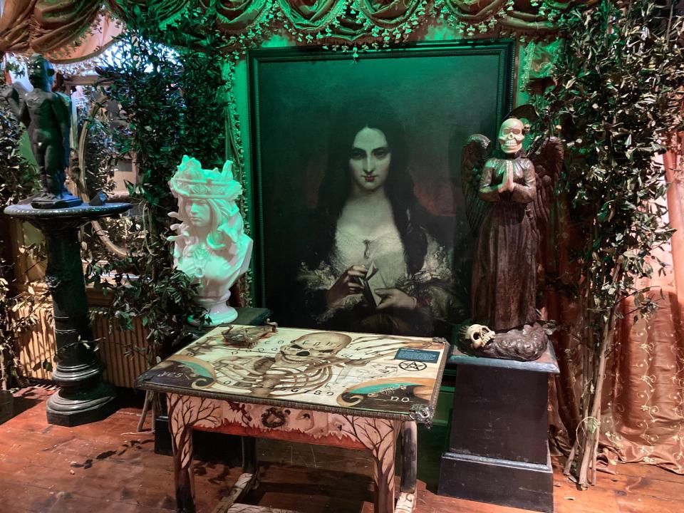Walking past Vincent Price’s creepy rocker, and more vampire stuff, Crimi stops. There's a display of Ouija boards, which an explainer card describes as “Windows into the Demonic.” One board, beneath a depiction of a female demon, was reportedly owned by the British occultist, Aleister Crowley.