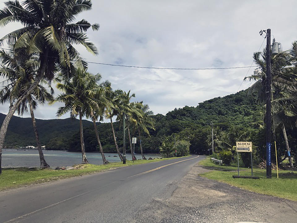 This Feb. 5, 2020 photo provided by Tisa Fa'amuli shows a tree lined street on Tutuila, the largest island in the American Samoa archipelago. A U.S. judge recently sided with three American Samoans in Utah wanting to be recognized as citizens. The American Samoa government is expected to appeal, and has until Monday to do so. Many in the U.S. territory are perfectly happy being U.S. nationals who can't vote in most federal elections or run for office outside American Samoa. (Tisa Fa'amuli via AP)