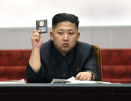 North Korean leader Kim Jong-Un holds up his ballot during the fifth session of the 12th Supreme People's Assembly of North Korea at the Mansudae Assembly Hall in Pyongyang in this April 13, 2012 file photo released by the North's KCNA on April 14, 2012. REUTERS/KCNA