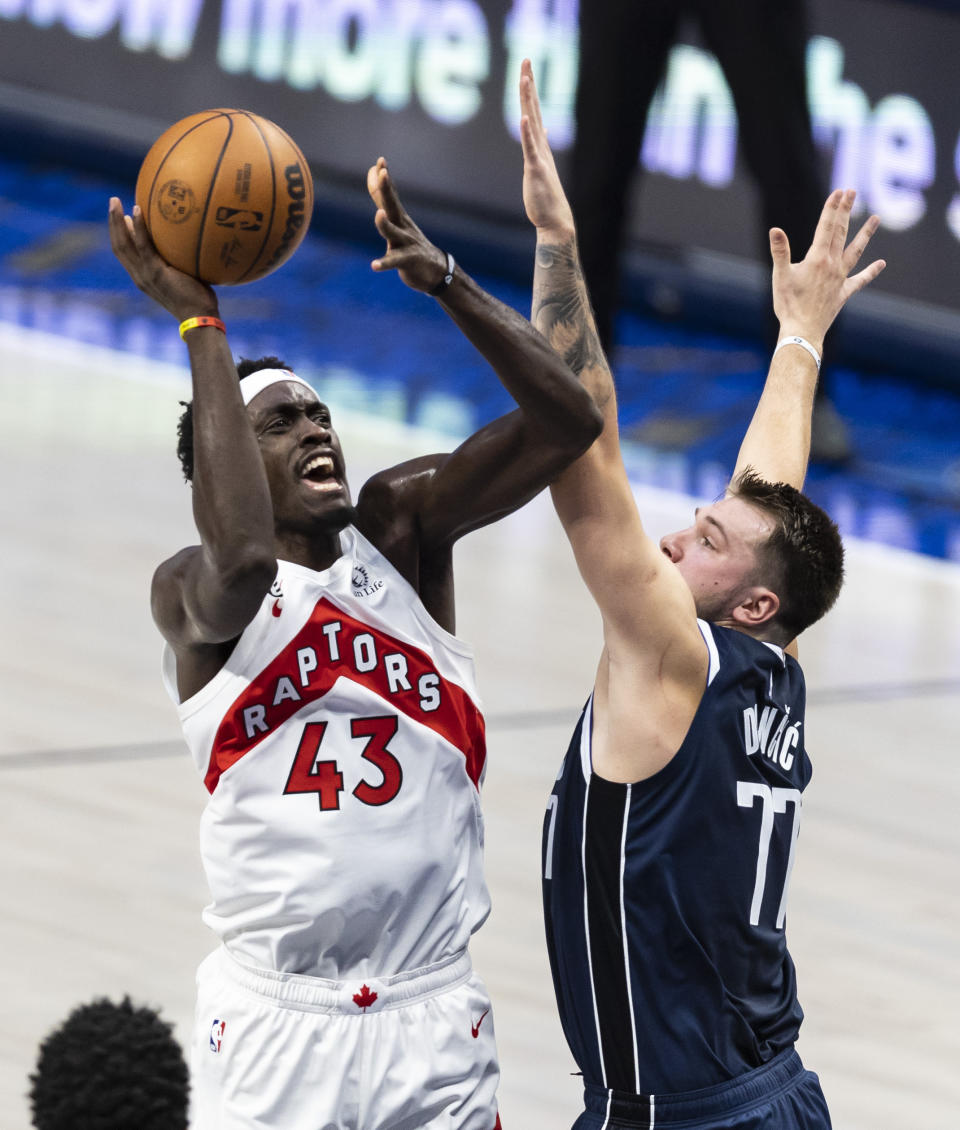 Toronto Raptors forward Pascal Siakam (43) shoots as Dallas Mavericks guard Luka Doncic (77) defends during the first half of an NBA basketball game Friday, Nov. 4, 2022, in Dallas. (AP Photo/Brandon Wade)