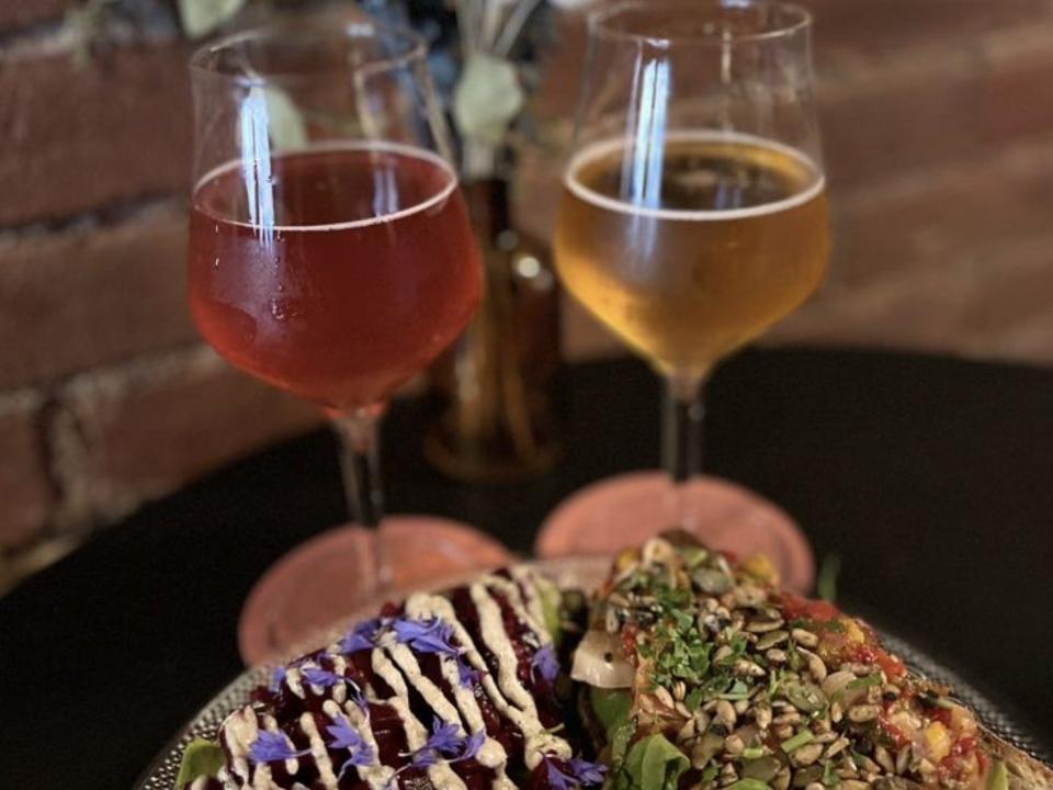 Two glasses of beer and avocado toast from Fox Tale Fermentation Project