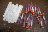 FILE - In this May 13, 2020, file photo, test swabs and specimen tubes sit on a table at a COVID-19 testing site at the Abyssinian Baptist Church in the Harlem neighborhood of New York. Public health officials have said robust testing for the coronavirus is essential to safely lifting stay-at-home orders and business closures, but states are creating confusion in the way they are reporting the data. (AP Photo/Mary Altaffer)