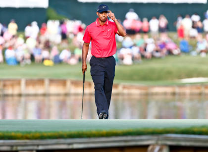 Tiger Woods tips his hat to the crowd on the 17th green. (USA Today)