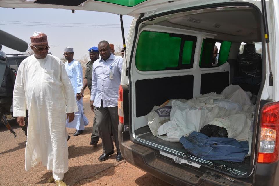 Ibrahim Gaidam, Governor of Yobe state, left, looks at bodies of students inside an ambulance outside a mosque in Damaturu, Nigeria, Tuesday, Feb. 25, 2014. Islamic militants killed dozens of students in a pre-dawn attack Tuesday on a northeast Nigerian school some 45 miles from the city, survivors said. (AP Photo)