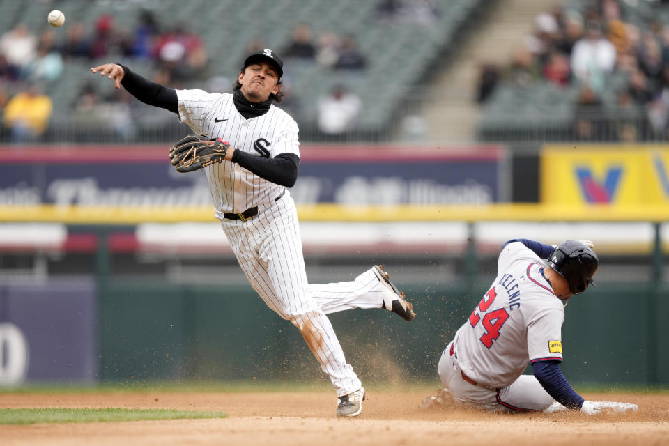 Chicago White Sox's Nicky Lopez throws to first after forcing Atlanta Braves' Jarred Kelenic out at second during the third inning of a baseball game Monday, April 1, 2024, in Chicago. (AP Photo/Charles Rex Arbogast)