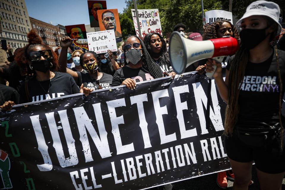 Protesters chant as they march after a Juneteenth rally at the Brooklyn Museum, Friday, June 19, 2020, in the Brooklyn borough of New York. Juneteenth commemorates when the last enslaved African Americans learned they were free 155 years ago. Now, with support growing for the racial justice movement, 2020 may be remembered as the year the holiday reached a new level of recognition. (AP Photo/John Minchillo)