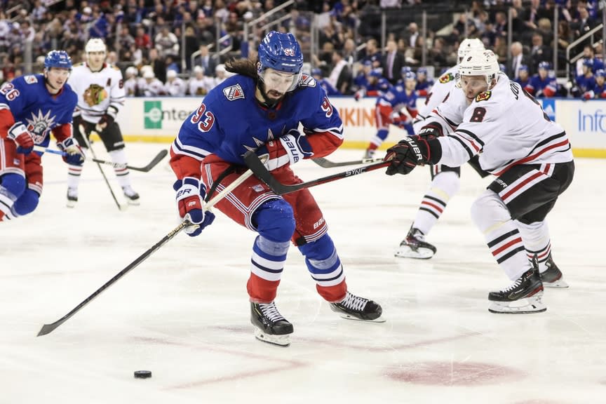 New York Rangers center Mika Zibanejad (93) and Chicago Blackhawks defenseman Jack Johnson (8) battle for control of the puck in the second period at Madison Square Garden.