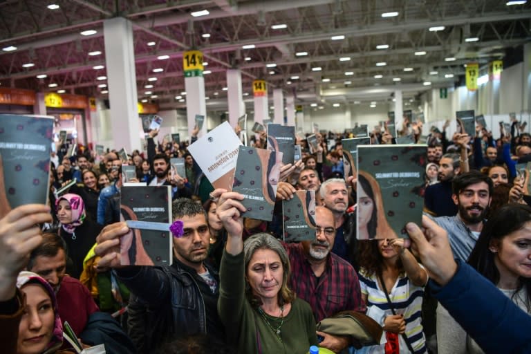 Demirtas supporters hold up the book of short stories he wrote in prison