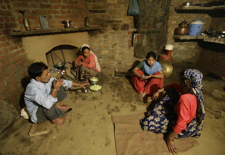 In this Aug. 24, 2012 photo, Shoba Bisht, second right, sits with her family at the kitchen she has helped build with money earned from working at B2R, in Simayal, India. Before B2R arrived in Simayal, local women had little option but to marry right out of school, and educated young men had to travel far to seek respectable jobs. (AP Photo/Saurabh Das)