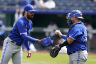 Toronto Blue Jays starting pitcher Robbie Ray, left, takes the ball from catcher Alejandro Kirk, right, after loading the bases in the first inning of a baseball game against the Kansas City Royals at Kauffman Stadium in Kansas City, Mo., Sunday, April 18, 2021. (AP Photo/Orlin Wagner)