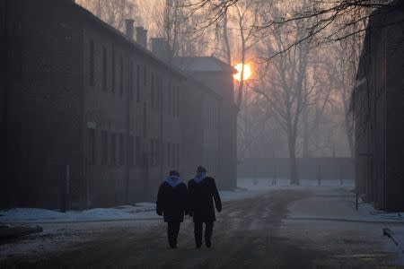 Survivors walk in the former Nazi German concentration and extermination camp Auschwitz-Birkenau in Oswiecim, Poland January 27, 2017, to mark the 72nd anniversary of the liberation of the camp by Soviet troops and to remember the victims of the Holocaust. Agency Gazeta/Kuba Ociepa/via REUTERS