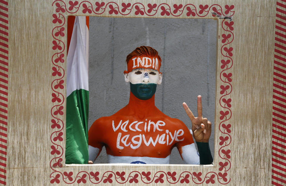 FILE - In this June 12, 2021, file photo, Rajkumar Haryani, 38, who painted his body to create awareness about vaccination against the coronavirus poses for photographs after getting a dose of Covishield vaccine in Ahmedabad, India. Starting June 21, 2021, every Indian adult can get a COVID-19 vaccine dose for free that was purchased by the federal government. The policy reversal announced last week ends a complex system of buying vaccines that worsened inequities in accessing vaccines. India is a key global supplier of vaccines and its missteps have left millions of people waiting unprotected. The policy change is likely to address inequality but questions remain and shortages will continue. (AP Photo/Ajit Solanki, File)