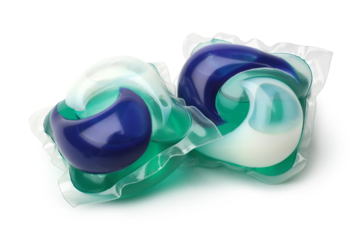 Two green-and-blue laundry detergent pods.