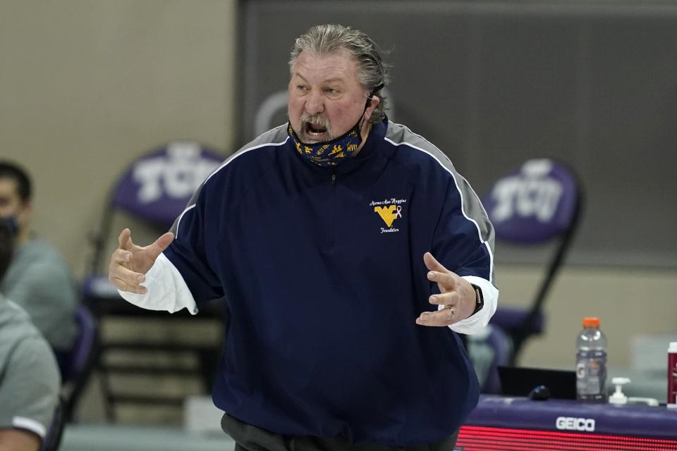 FILE - West Virginia head coach Bob Huggins shouts at an official during the second half of an NCAA college basketball game against TCU in Fort Worth, Texas, in this Tuesday, Feb. 23, 2021. Huggins enters his 40th season as a head coach with 900 career wins and a new two-year contract extension. (AP Photo/Tony Gutierrez, File)