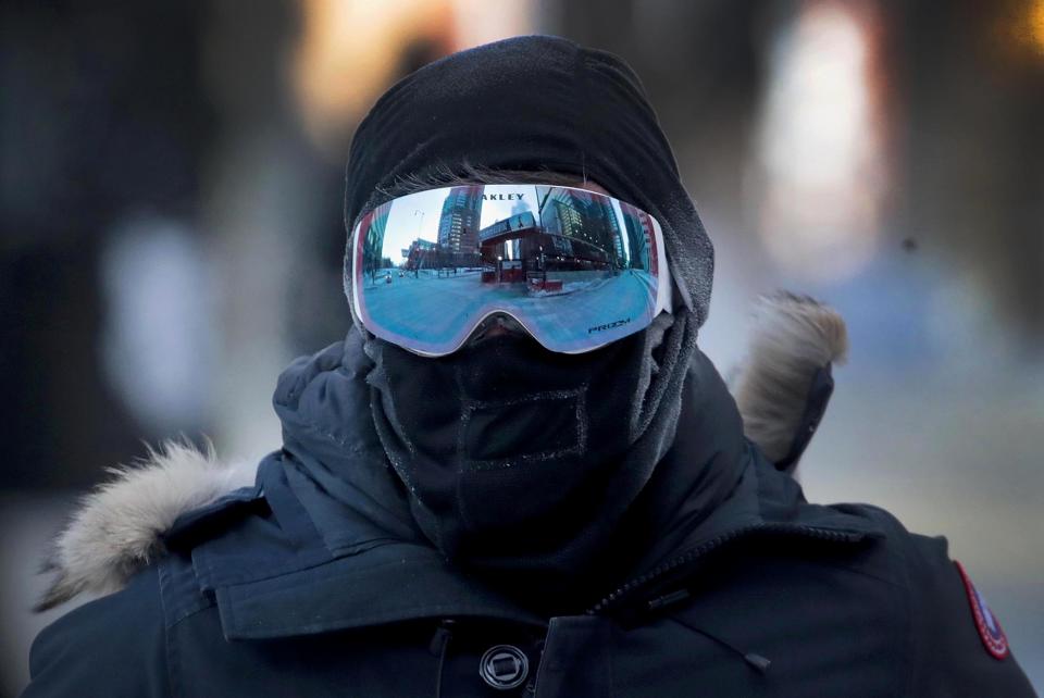 A commuter walks through downtown in subzero temperatures during an extremely light morning rush hour on Jan. 30, 2019 in Chicago