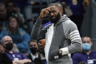 Los Angeles Lakers forward LeBron James looks on during the first half of an NBA basketball game against the Charlotte Hornets in Charlotte, N.C., Friday, Jan. 28, 2022. (AP Photo/Jacob Kupferman)