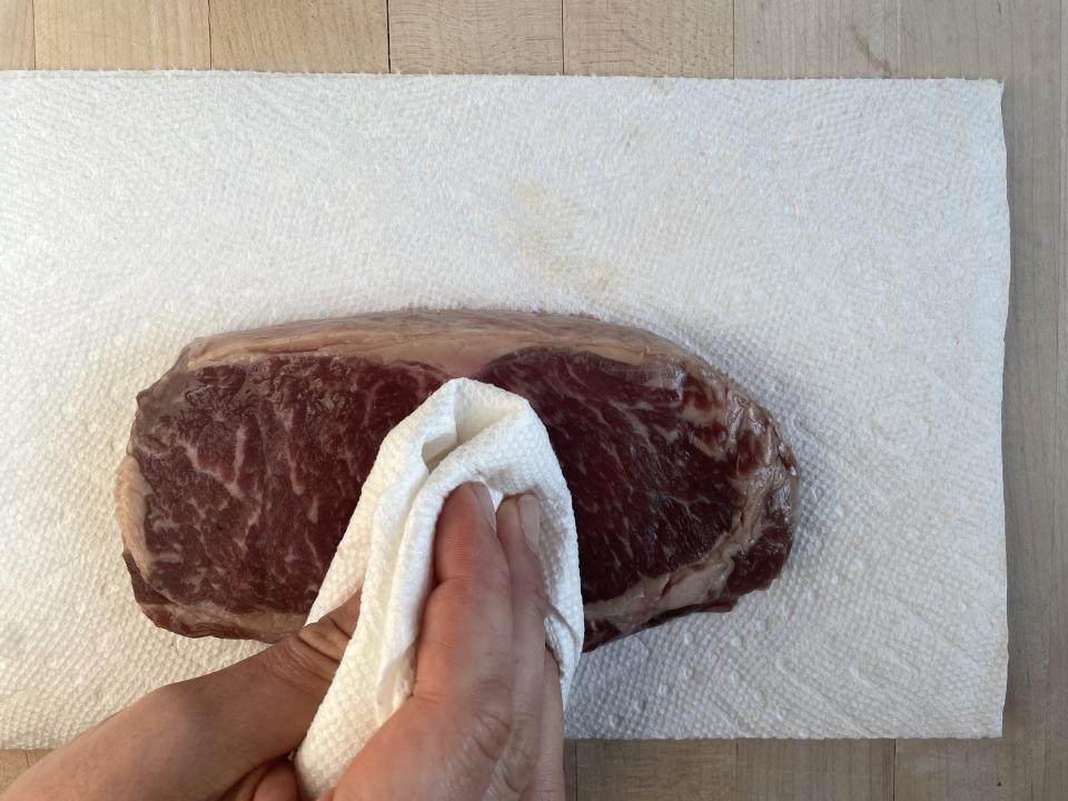 Pat steak completely dry before seasoning. (Katie Stilo)