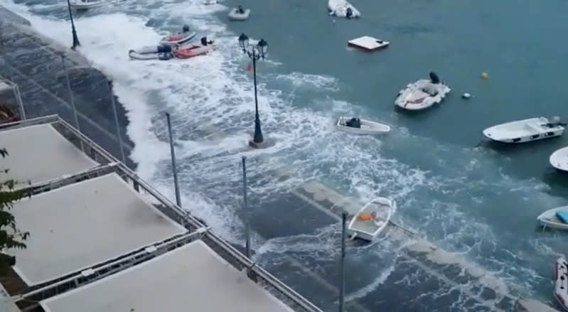 Waves flood the street in Villefranche-Sur-Mer