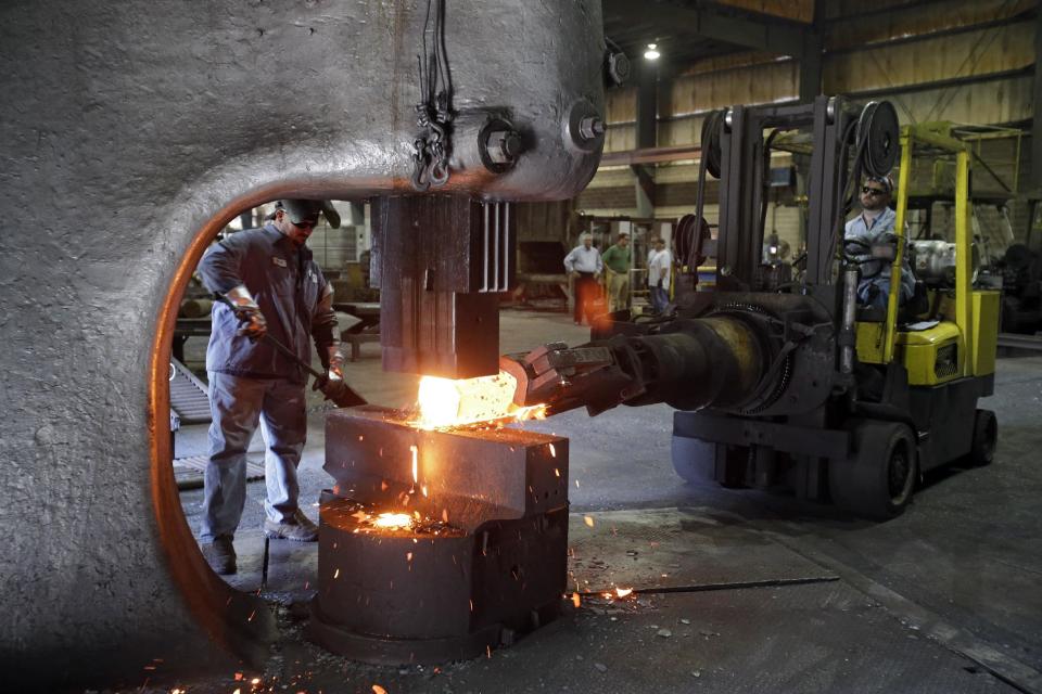 In this Thursday, Sept. 6, 2012, photo, workers form a large spindle at Solmet Technologies in Canton, Ohio. U.S. manufacturing grew for the first time in four months, buoyed by a jump in new orders in September. The increase was a hopeful sign that the economy is improving. The Institute for Supply Management, a trade group of purchasing managers, said Monday, Oct. 1, 2012, that its index of factory activity rose to 51.5. That's up from 49.6 in August. (AP Photo/Mark Duncan)