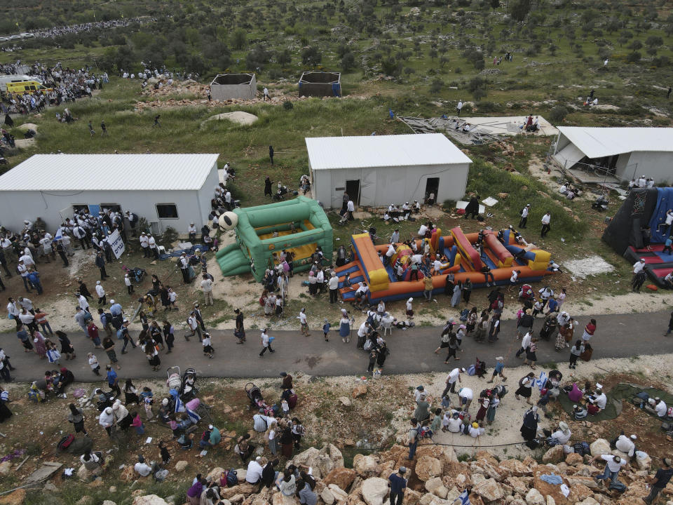 Israeli, most of the settlers gather in the outpost of Eviatar in the West Bank, Monday, April 10, 2023. Thousands led by hardline ultranationalist Jewish settlers marched to the unauthorized settlement outpost Eviatar in the northern West Bank that was cleared by the Israeli government in 2021, protected by a large contingent of Israeli soldiers and police. (AP Photo/Ariel Schalit)