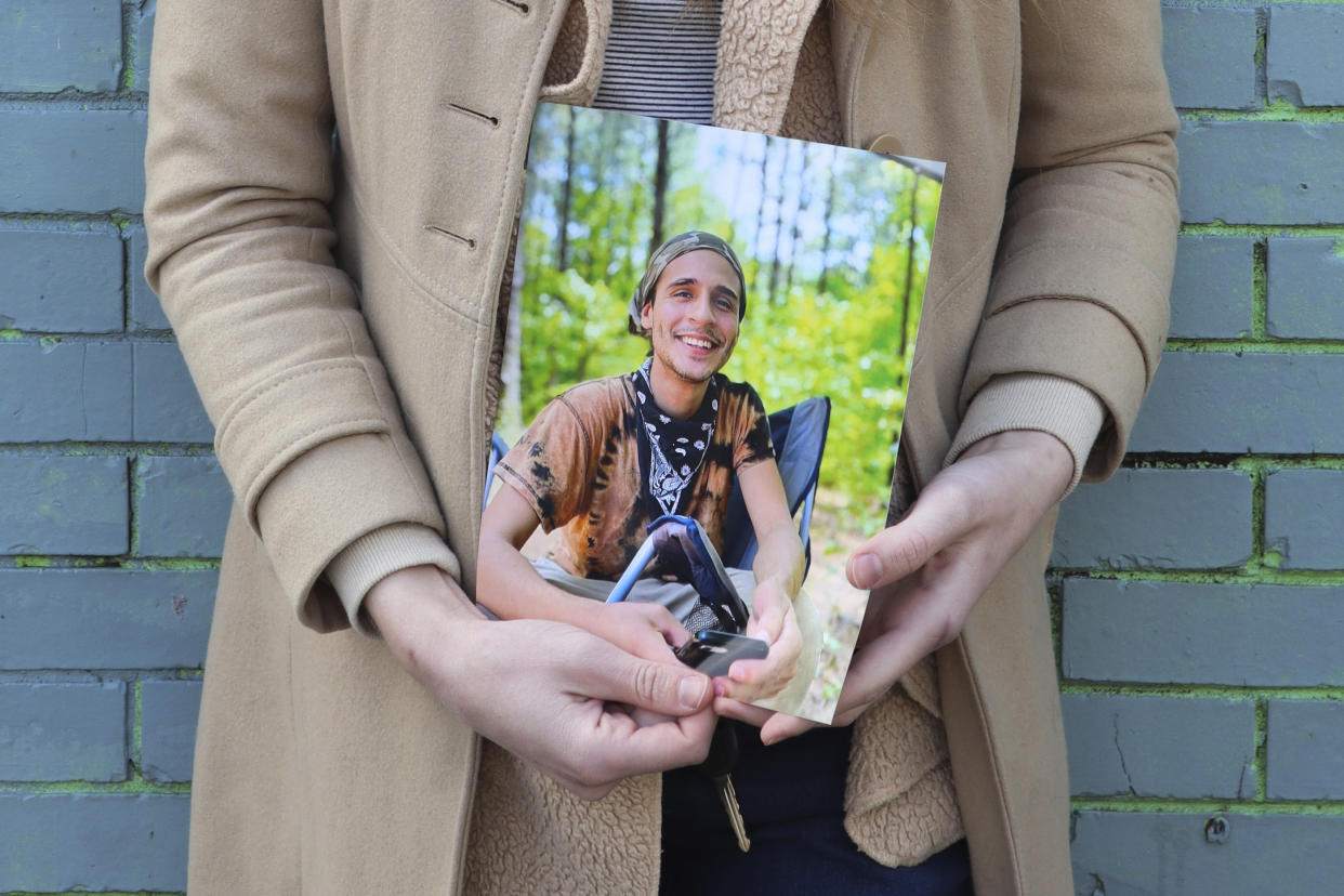 Vienna holds a photo of her slain partner, Tortuguita, in Atlanta on Thursday, Jan. 26, 2023. Officials have said officers fatally shot Tortuguita in self-defense after the protester shot a trooper on Wednesday, Jan. 18, but activists argue it was a state-sanctioned murder of a beloved community member who was renowned for having a big heart. (AP Photo/R.J. Rico)